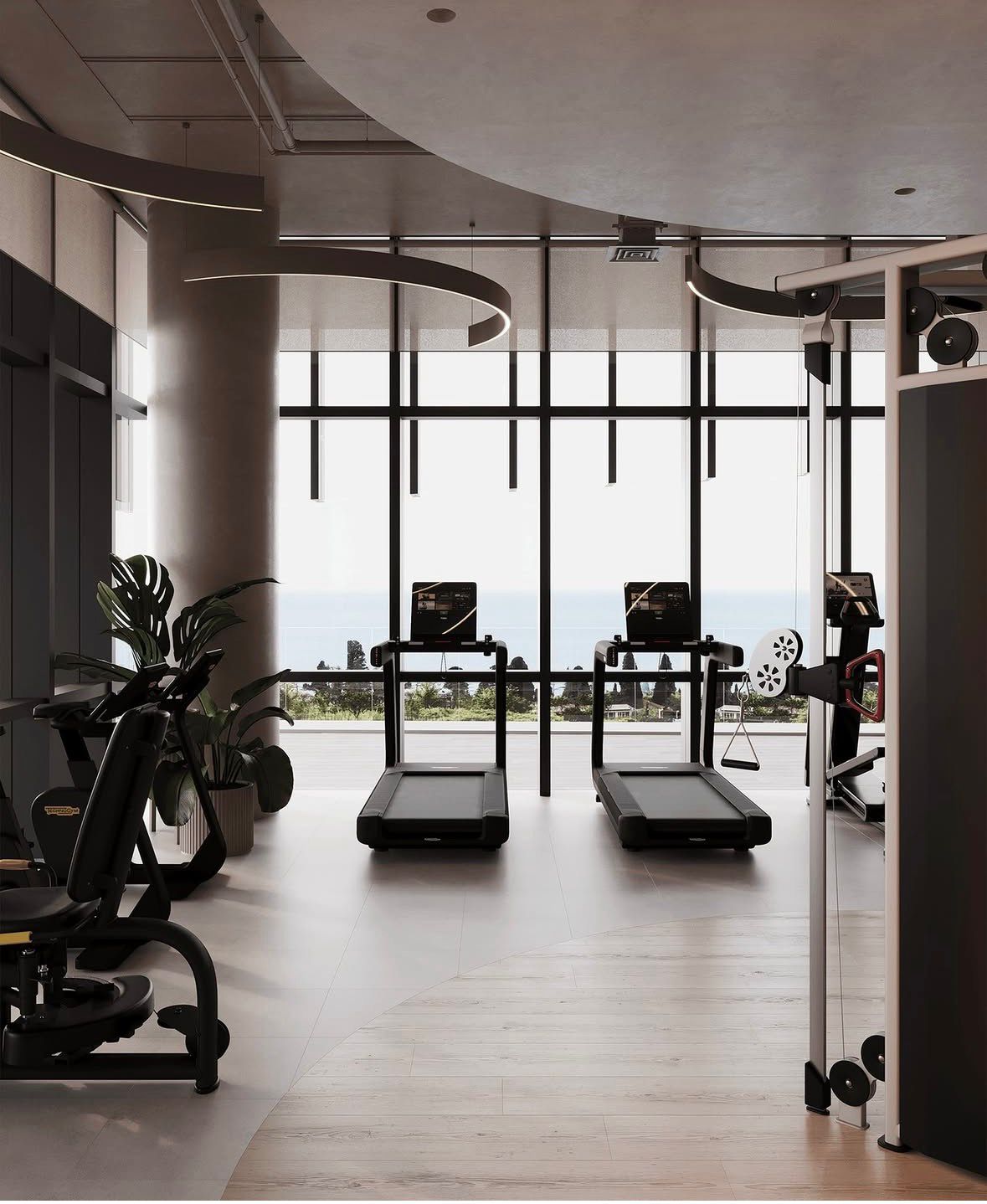 A luxury private gym interior — treadmills, ocean view, curved architectural lighting